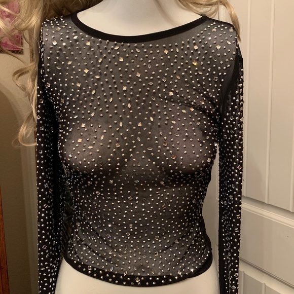 Sheer beaded long sleeve evening top.